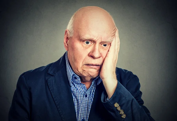 Portrait of elderly desperate sad man