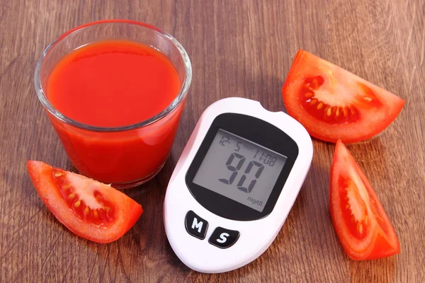 Glucometer, fresh tomato and tomato juice, diabetes and healthy nutrition