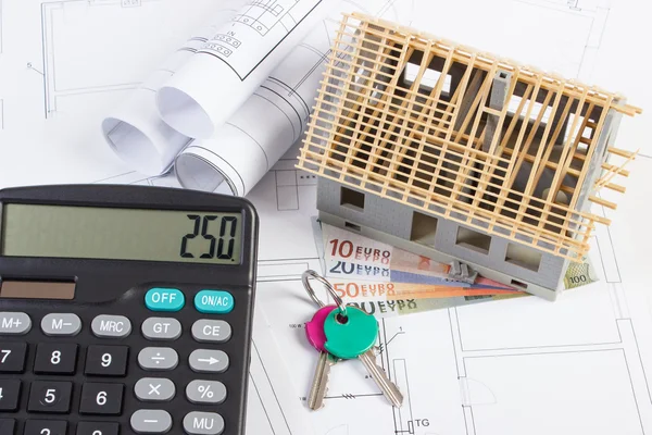 House under construction, keys, calculator, currencies euro and electrical drawings, concept of building home