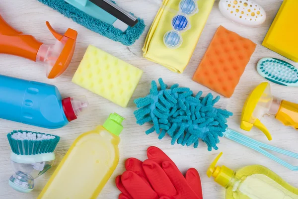 Collection of various colorful household cleaning product on wooden background