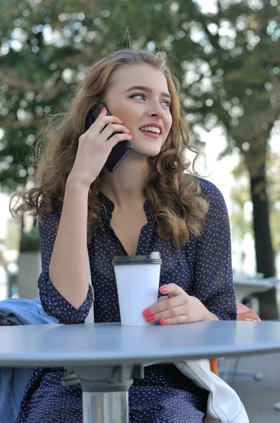 Beautiful girl with long hair talking on a cell phone
