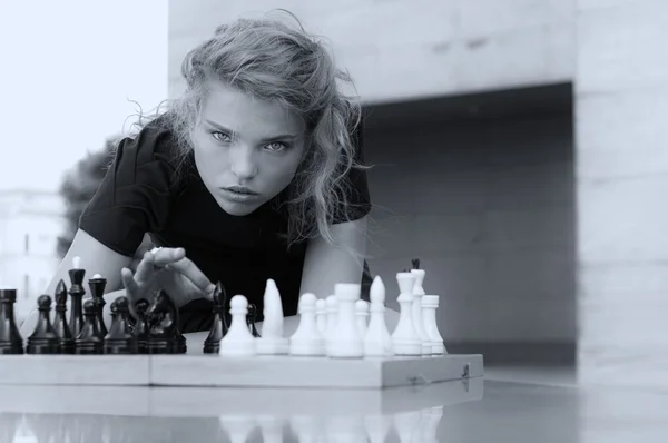 She knocks the board chess pieces
