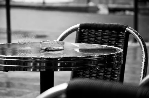 Rain falling on a restaurant table in outdoor