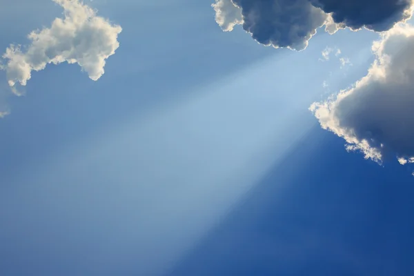 Light rays of god on clear blue sky
