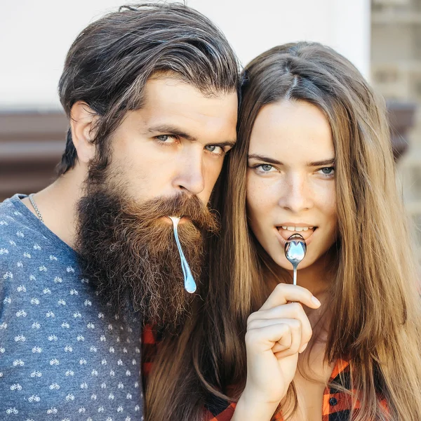 Young couple with tea spoon