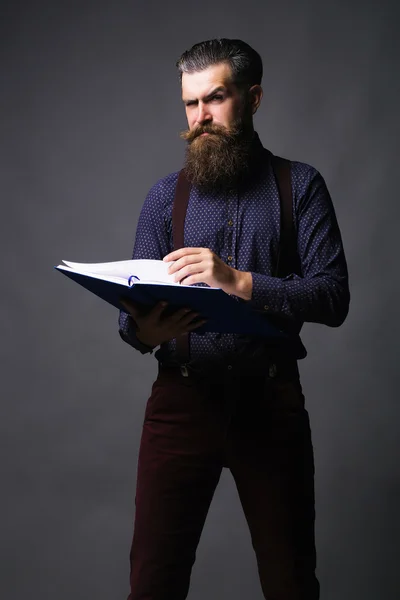 Handsome man reads journal