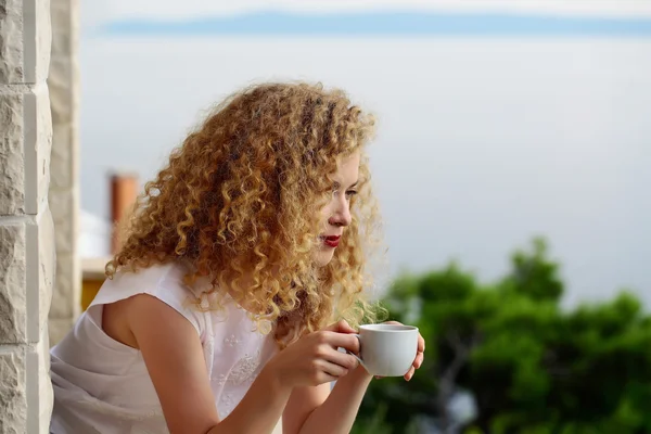 Pretty woman with coffee cup