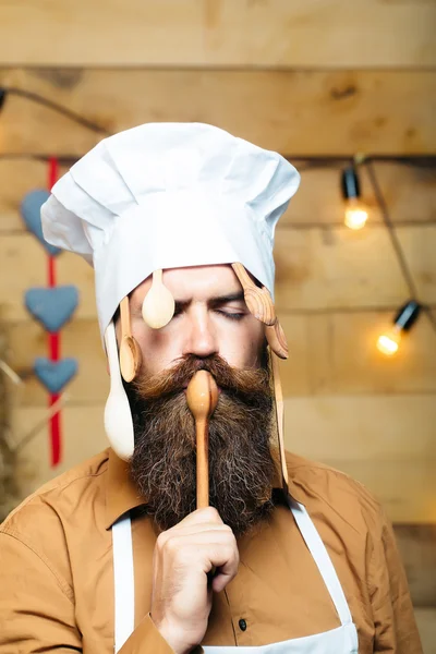 Chef cook with wooden spoons