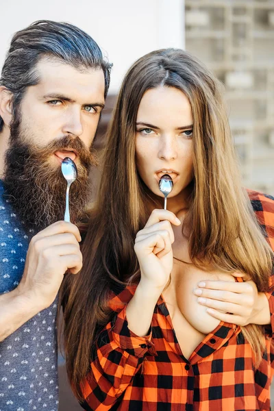 Young couple with tea spoon