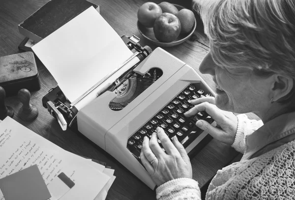 Woman writing on typewriter machine