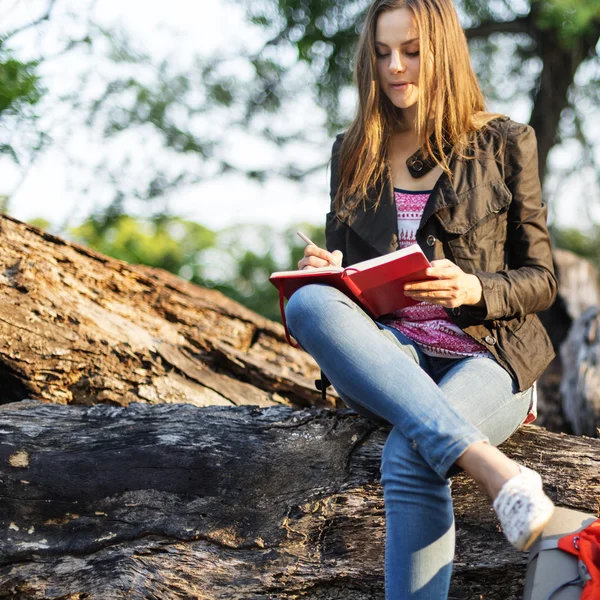 Woman writing notes in nature