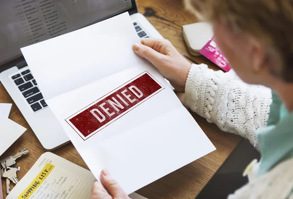 Senior woman holding white paper