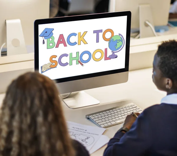 Classmate pupils using computer