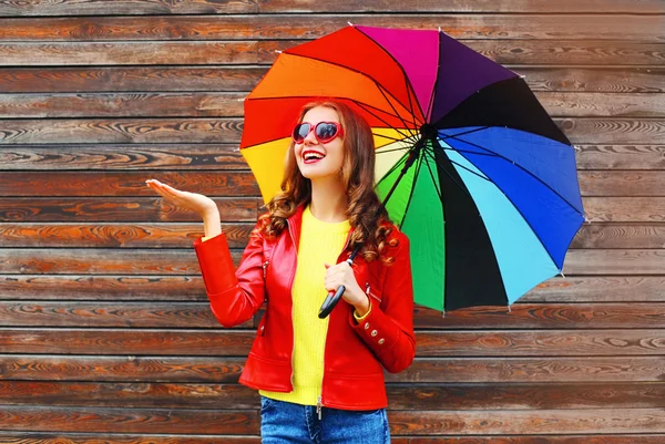 Happy cheerful smiling woman with colorful umbrella in autumn da