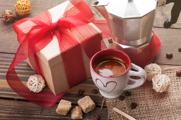 Cup of coffee, gift with red ribbon, brown sugar