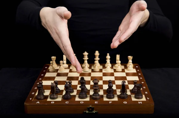Closeup beautiful hands point to the opponent chess pieces on wo