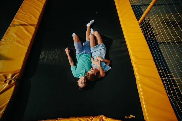 Couple lie on trampoline in the park