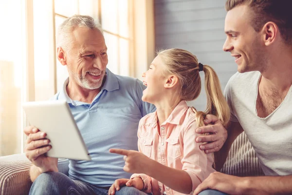 Grandpa, dad and little girl at home