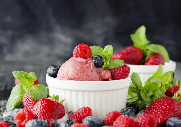 Fruit ice cream with fresh strawberries, blueberries and raspberries