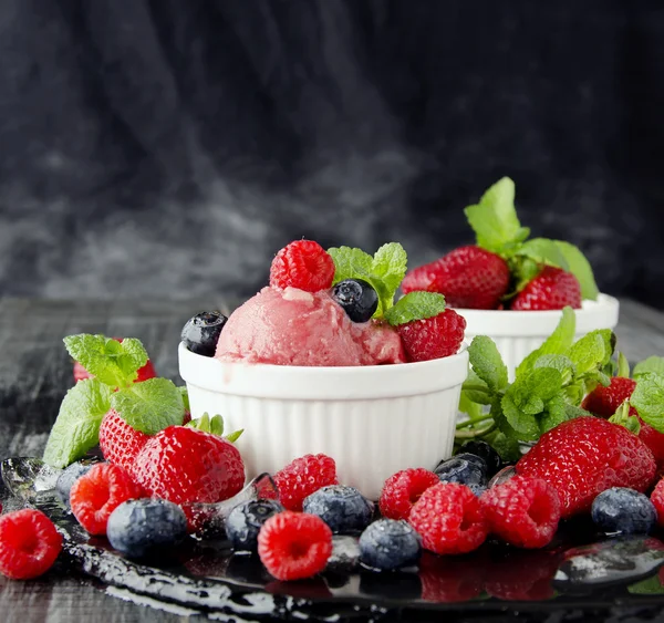 Fruit ice cream with fresh strawberries, blueberries and raspberries