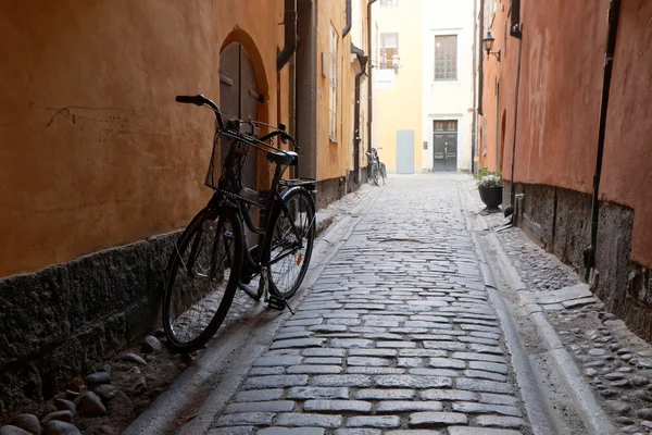 Retro bicycle in an old alley surrounded by old architecture