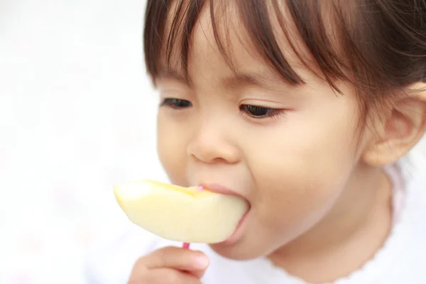 Japanese girl eating an apple (1 year old)