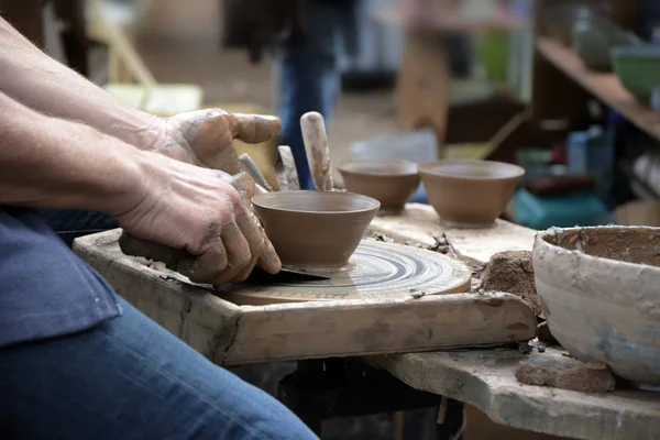 Potter creating a new ceramic made of clay on the potter's wheel