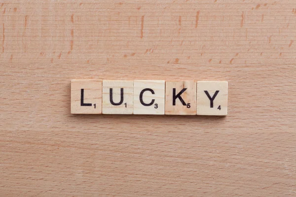 Scrabble letters spelling the word lucky.