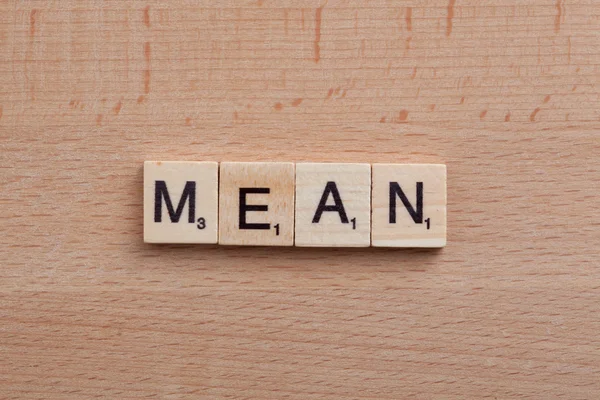 Scrabble letters spelling the word mean.