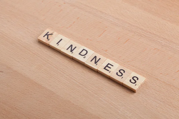 Scrabble letters spelling the word kindness.