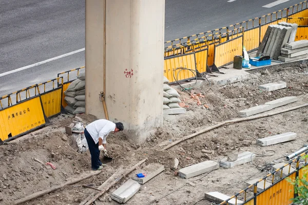 Construction worker in a street of Shanghai