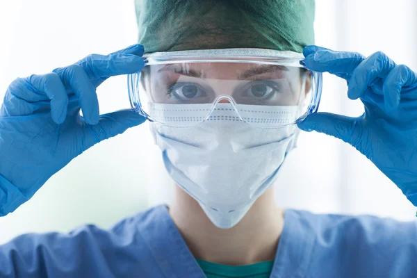 Surgeon wearing protective glasses