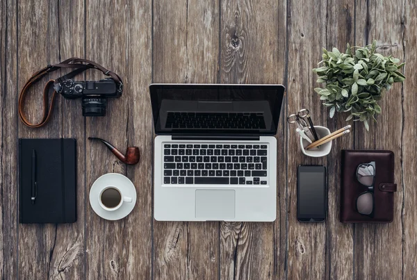 Hipster wooden desktop with lapto