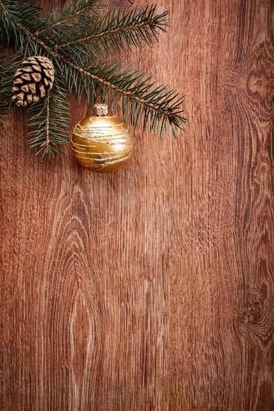 Christmas ornaments and fir tree branch on a rustic wooden background. Xmas card. Happy New Year. Top view with copy space