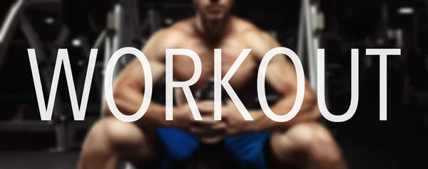 The word WORKOUT in the blurry background bodybuilder in the gym.