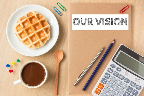 Our vision text message on paper book and office supplies, pen, coffee on wood desk , copy space / business concept / view from above, top view