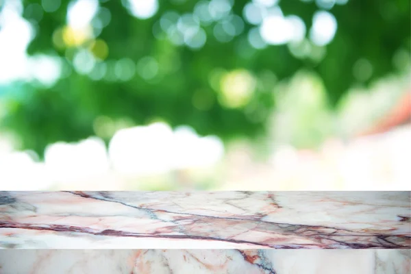 White marble stone countertop or table on backdrop blurred nature background / for display or montage your products / empty marble background concept