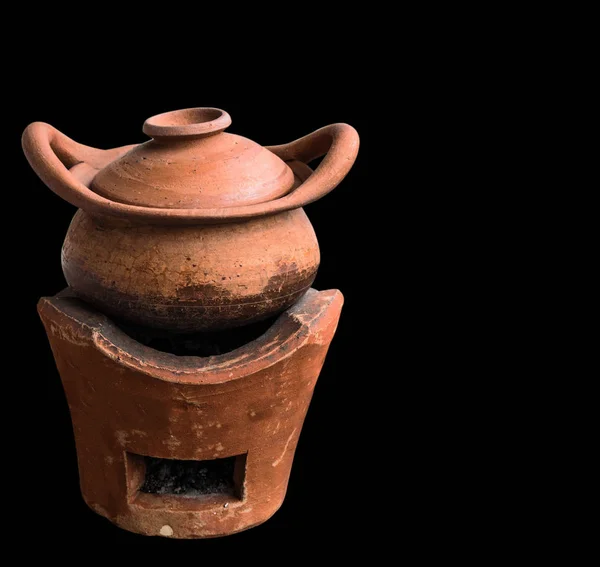 Clay pot on black background.