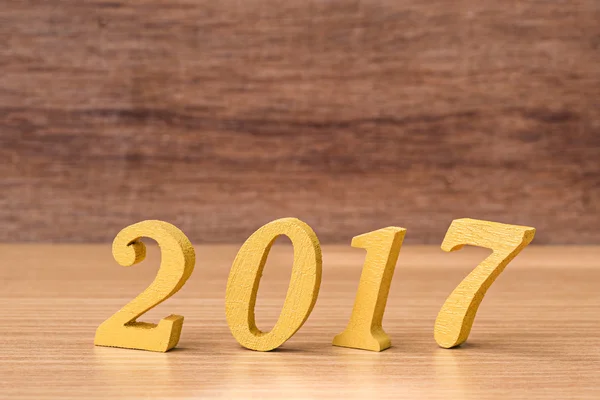 Gold wooden font of year 2017 on wood table
