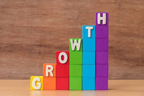 Text GROWTH on growing stack of colorful wood cube