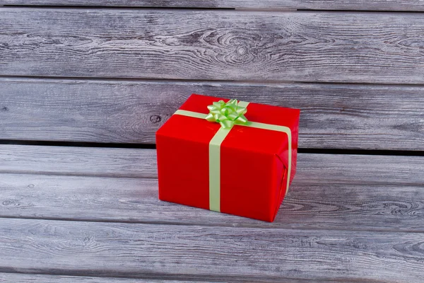 Red gift box with a light green bow.