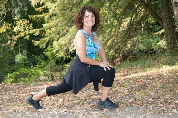 Healthy middle aged woman stretching before Fitness and Exercise