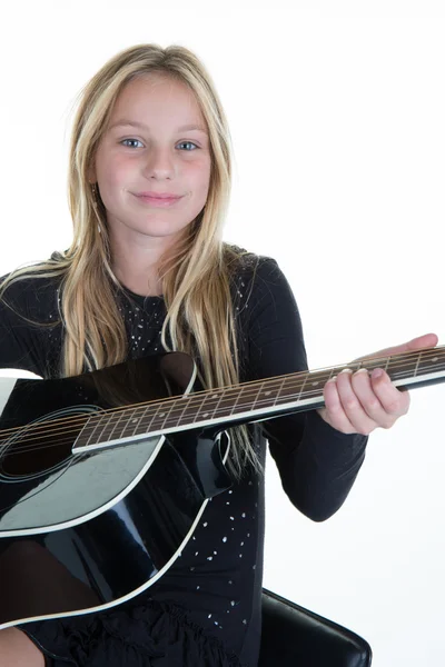 Blond kid girl learning play guitar isolated