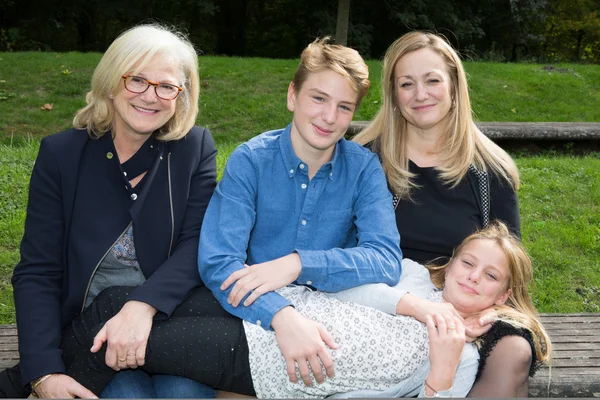 Different generation posing in the park outside