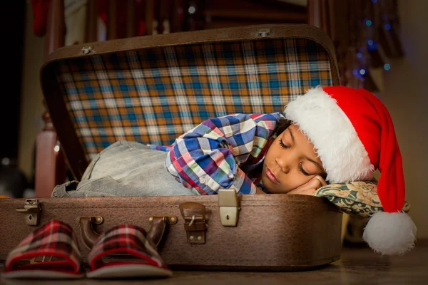 Boys Christmas nap inside suitcase.