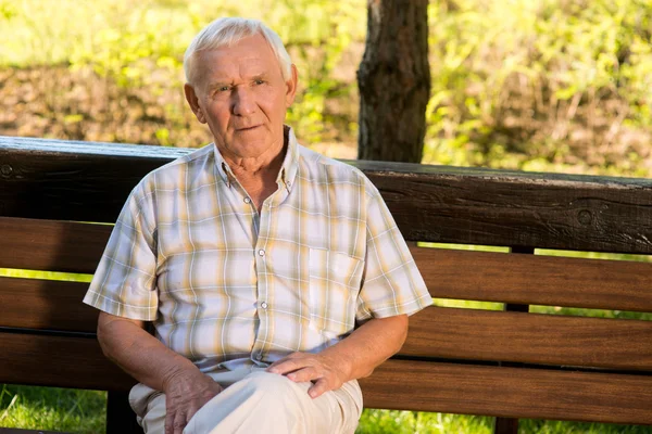 Elderly man on a bench.
