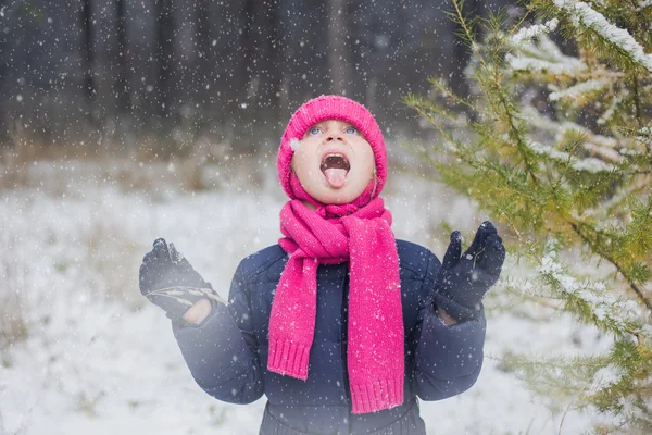 Girl walks in the snow-covered forest.