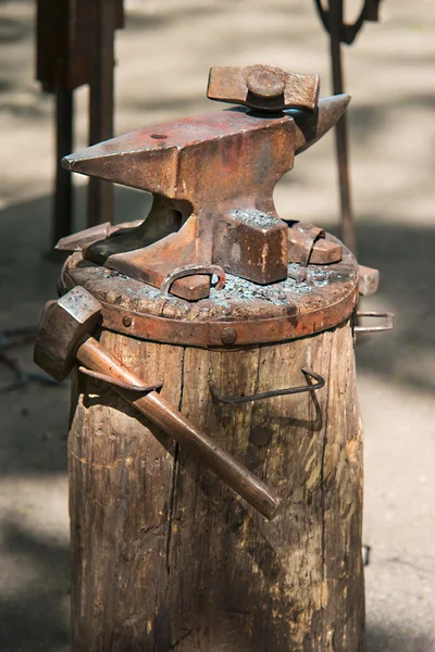 Blacksmith anvil with the tools on the barrel, close-up