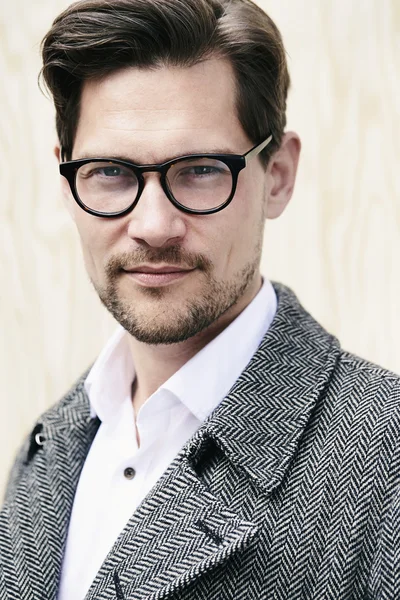 Handsome man in glasses and coat