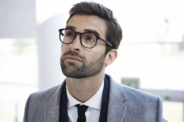 Thoughtful businessman in glasses